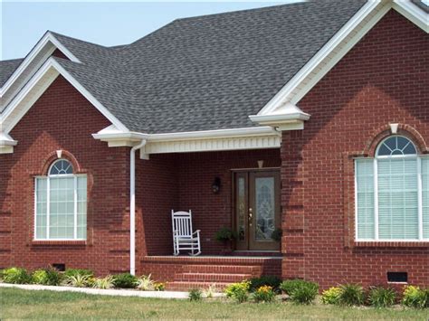 charcoal gray metal roof on red brick house|black roof color for brick house.